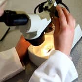 A woman looking through a microscope. New ways to treat prostate cancer could be on the horizon. Picture: David Davies/PA Wire