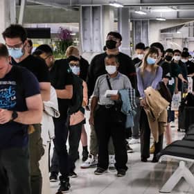 Incoming passengers line up to have their temperatures taken and health assessed at a checkpoint for people flying in from a list of countries that include China, Hong Kong, Macau, South Korea, Iran and Italy, as a precautionary measure against the spread of the Covid-19 novel coronavirus in Thailand.