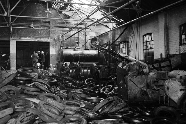 A mass of molten rubber and scrap tyres lies round two 1000 gallon paraffin oil tanks after another fire at the North British Rubber Company in May 1960.