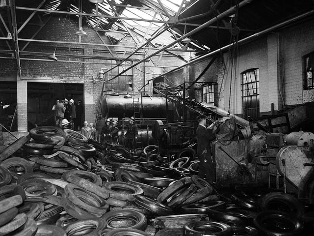 A mass of molten rubber and scrap tyres lies round two 1000 gallon paraffin oil tanks after another fire at the North British Rubber Company in May 1960.