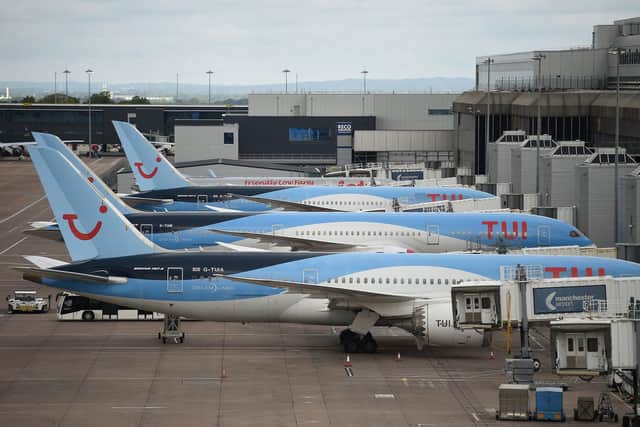 Aircraft grounded due to the COVID-19 pandemic, including planes operated by TUI. (Photo by OLI SCARFF/AFP via Getty Images)