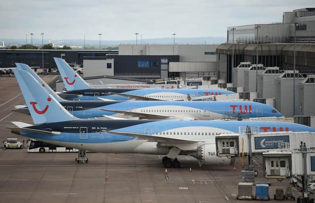 Aircraft grounded due to the COVID-19 pandemic, including planes operated by TUI. (Photo by OLI SCARFF/AFP via Getty Images)