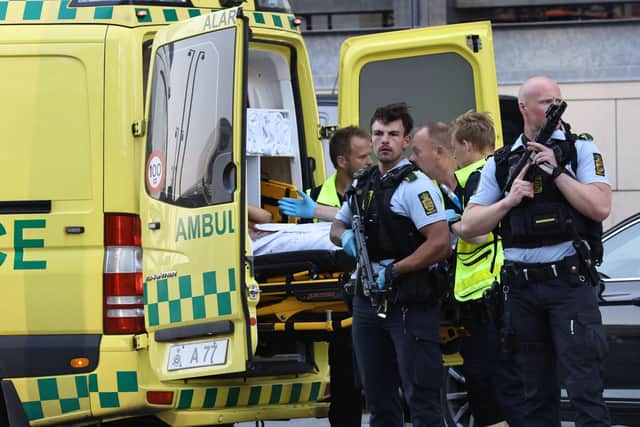 An ambulance and armed police outside the Field's shopping center, in Orestad, Copenhagen, Denmark, Sunday, July 3, 2022, after reports of shots fired. Danish police say several people have been shot at a Copenhagen shopping mall. Copenhagen police said that one person has been arrested in connection with the shooting at the FieldÕs shopping mall on Sunday. Police tweeted that Òseveral people have been hitÓ but gave no other details. (Olafur Steinar Gestsson /Ritzau Scanpix via AP)