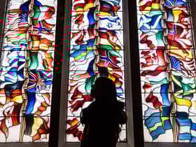 A stained glass memorial window in Lockerbie Town Hall depicting flags from all the nations that lost citizens in the bombing
