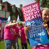 Campaigners in support of assisted dying gather outside the Houses of Parliament in 2015