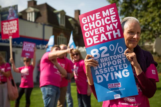 Campaigners in support of assisted dying gather outside the Houses of Parliament in 2015