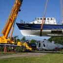 A former RNLI lifeboat is lowered into Martyn Steedman's camping site at Mains Farm in Thornhill, Stirlingshire (Picture: Andrew Milligan/PA Wire)