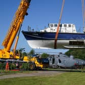 A former RNLI lifeboat is lowered into Martyn Steedman's camping site at Mains Farm in Thornhill, Stirlingshire (Picture: Andrew Milligan/PA Wire)