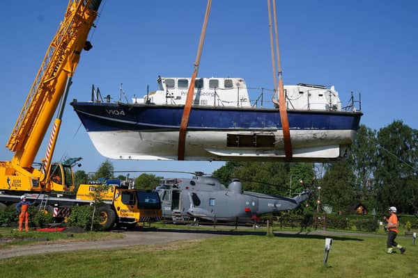 A former RNLI lifeboat is lowered into Martyn Steedman's camping site at Mains Farm in Thornhill, Stirlingshire (Picture: Andrew Milligan/PA Wire)