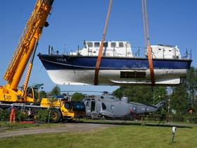 A former RNLI lifeboat is lowered into Martyn Steedman's camping site at Mains Farm in Thornhill, Stirlingshire (Picture: Andrew Milligan/PA Wire)