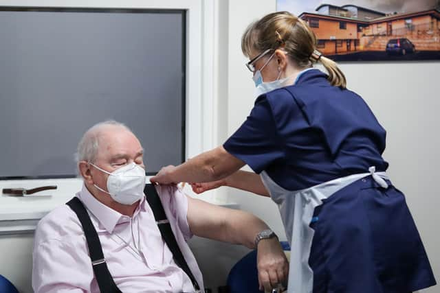 Ian Cormack receives a dose of AstraZeneca vaccine from Ruth Davies, a practice nurse, at the Pentland Medical Practice on January 7, 2021 in Currie, Scotland. Photo by Russell Cheyne - WPA Pool/Getty Images