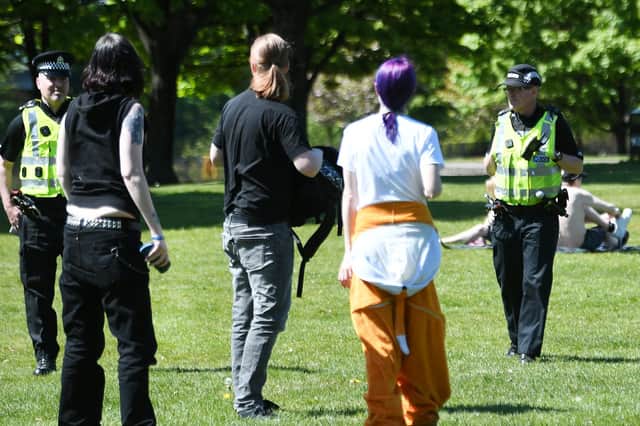 Police speak to sunbathers in Glasgow Green as the weather warmed up around Scotland on 6 May. Picture: John Devlin.
