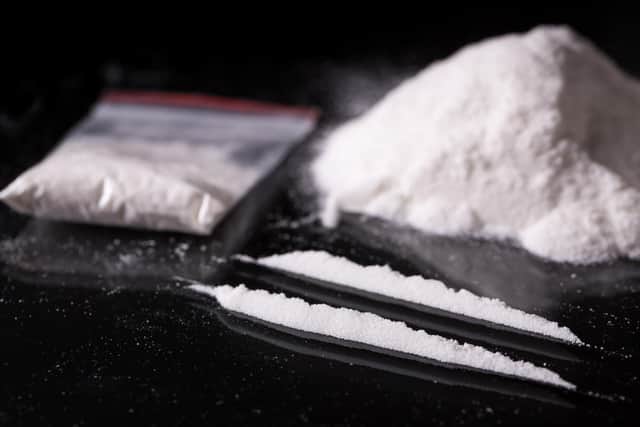 Plastic packet, two lines and pile of cocaine