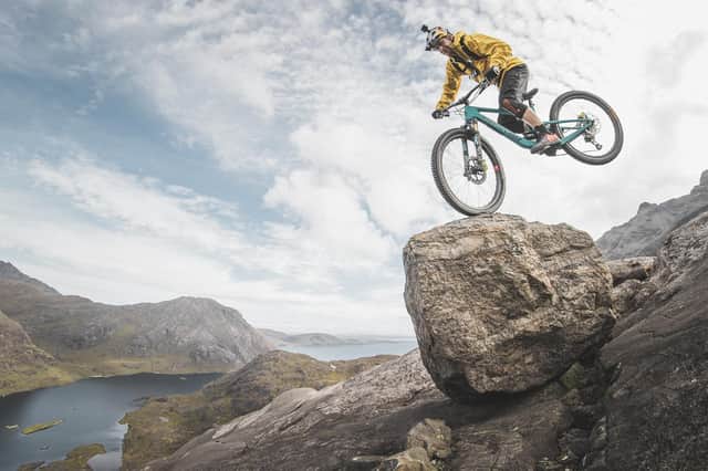 Danny MacAskill cycles down a moderate rock climb known as The Slabs on Skye