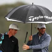 World No 1 Scottie Scheffler of the United States and his caddie Ted Scott look on from under an umbrella during the second round of the Genesis Scottish Open at The Renaissance Club. Picture: Jared C. Tilton/Getty Images.