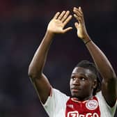 Ajax defender Calvin Bassey applauds supporters after his team's 4-0 victory over his former club Rangers. (Photo by KENZO TRIBOUILLARD/AFP via Getty Images)