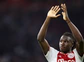 Ajax defender Calvin Bassey applauds supporters after his team's 4-0 victory over his former club Rangers. (Photo by KENZO TRIBOUILLARD/AFP via Getty Images)