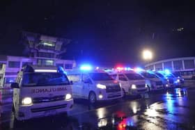 Ambulances wait to carry passengers from a London-Singapore flight that encountered severe turbulence, after it landed in Bangkok, Thailand.