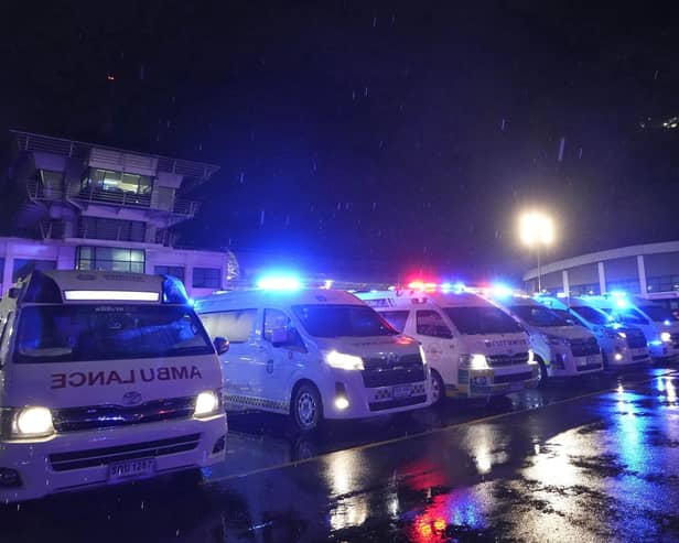 Ambulances wait to carry passengers from a London-Singapore flight that encountered severe turbulence, after it landed in Bangkok, Thailand.