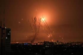 A salvo of rockets is fired by Palestinian militants from Gaza as an Israeli missile launched from the Iron Dome defence missile system attempts to intercept the rockets, fired from the Gaza Strip, over the city of Netivot in southern Israel .