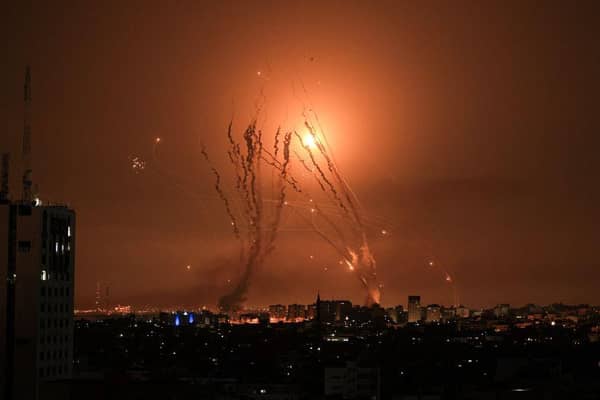 A salvo of rockets is fired by Palestinian militants from Gaza as an Israeli missile launched from the Iron Dome defence missile system attempts to intercept the rockets, fired from the Gaza Strip, over the city of Netivot in southern Israel .