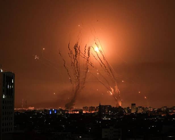 A salvo of rockets is fired by Palestinian militants from Gaza as an Israeli missile launched from the Iron Dome defence missile system attempts to intercept the rockets, fired from the Gaza Strip, over the city of Netivot in southern Israel .