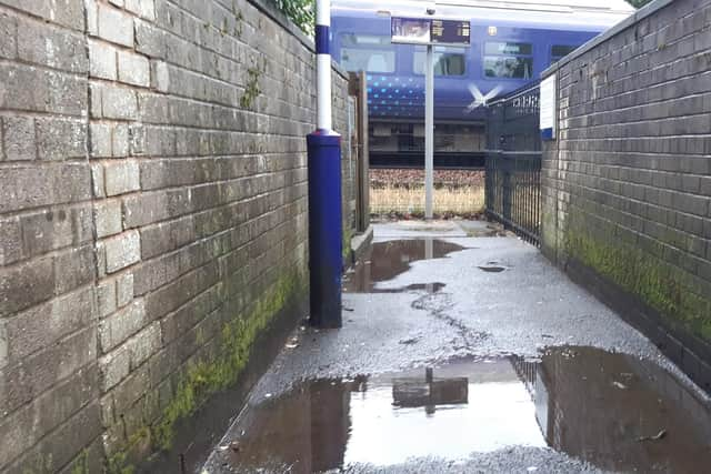 Flooding regularly covers this station entrance path in Glasgow. Picture: The Scotsman