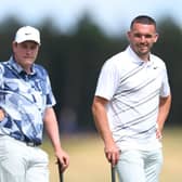 Bob Macintyre and John McGinn look on as one of the other players in their group hits a shot in the Genesis Scottish Open Pro Am at The Renaissance Club. Picture: Andrew Redington/Getty Images.