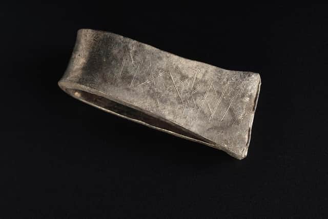 A Scandinavian-style silver arm ring found in the Viking-era Galloway Hoard with the runic inscription for the name Egbert, an Anglo Saxon name common in the kingdom of Northumbria. Picture: National Museums Scotland