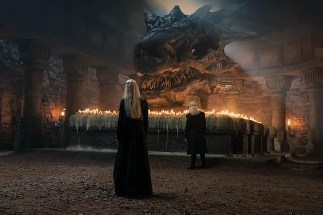 Princess Rhaenyra Targaryen (Milly Alcock) and King Viserys Targaryen (Paddy Considine) stand before the skull of Balerion the Black Dread in House of the Dragon, HBO.