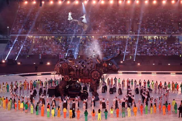 Performers remove the headpiece of The 'Raging Bull' during the opening ceremony