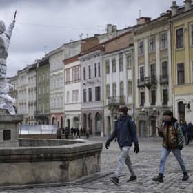 Statues are wrapped up around Lviv Town Hall. Volunteers are in the process of covering and wrapping statues and windows on many of the historically important buildings in the city. (Photo by Dan Kitwood/Getty Images)