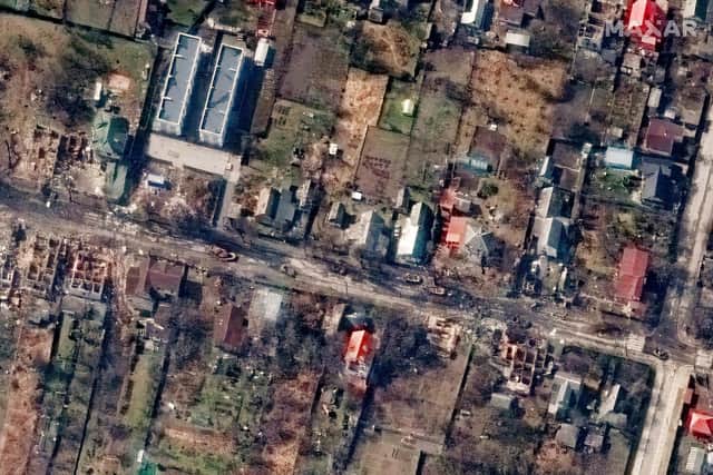This satellite image provided by Maxar Technologies shows an overview of destroyed houses and vehicles in a street in Bucha, Ukraine on Thursday March 31, 2022. (Satellite image ©2022 Maxar Technologies via AP)