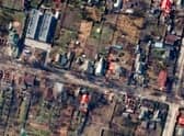 This satellite image provided by Maxar Technologies shows an overview of destroyed houses and vehicles in a street in Bucha, Ukraine on Thursday March 31, 2022. (Satellite image ©2022 Maxar Technologies via AP)