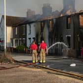 Houses in Wennington, east London, burn after grass fires spread into the village during the heatwave earlier this week (Picture: Carl Court/Getty Images)