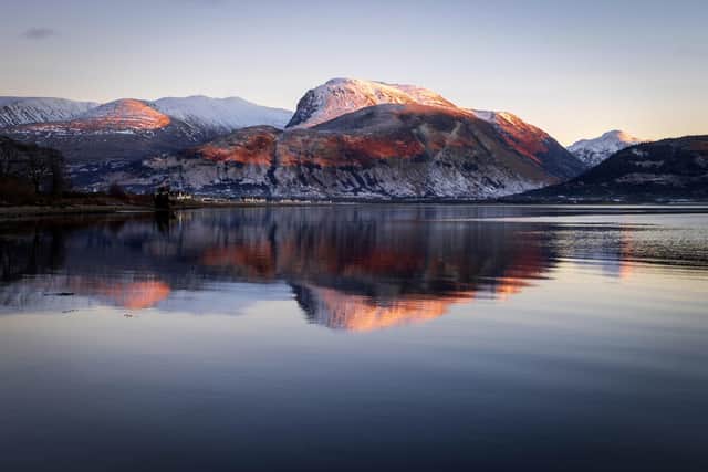 Ben Nevis is reflected in Loch Linnhe at sunset near Fort William in the western Scottish Highlands. Picture: Jane Barlow/PA Wire