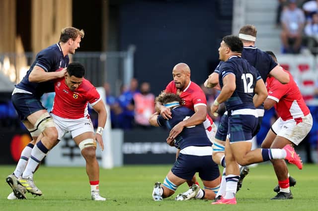 Afusipa Taumoepeau of Tonga tackles Jamie Ritchie of Scotland during the World Cup match in Nice.