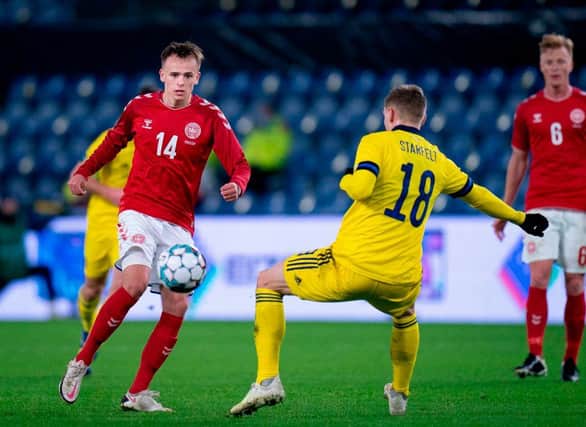 Denmark's Mikkel Damsgaard (L) and Sweden's Carl Starfelt vie for the ball (Photo by LISELOTTE SABROE/Ritzau Scanpix/AFP via Getty Images)