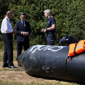 Prime Minister Andy Burnham speaks with John Craig, Interim Chief Coastguard, and Duncan Capps, Border Security Commander, by a recovered small inflatable boat, used by migrants crossing the English Channel, in Dover on August 2 (Picture: Jack Taylor / AFP via Getty Images)
