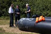 Prime Minister Andy Burnham speaks with John Craig, Interim Chief Coastguard, and Duncan Capps, Border Security Commander, by a recovered small inflatable boat, used by migrants crossing the English Channel, in Dover on August 2 (Picture: Jack Taylor / AFP via Getty Images)
