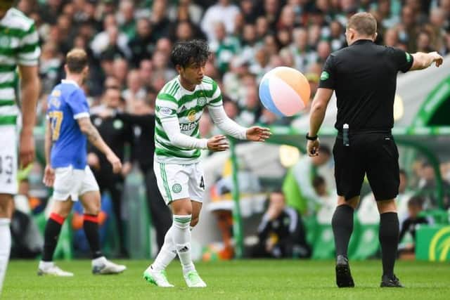 Beachballs blew from the stands onto the pitch, leading Celtic midfielder to Reo Hatate to intervene with one inflatable (Photo by Craig Foy / SNS Group)