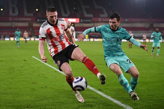 John Lundstram being closed down by Scotland captain Andy Robertson in a match between Sheffield United and Liverpool. Picture: Getty