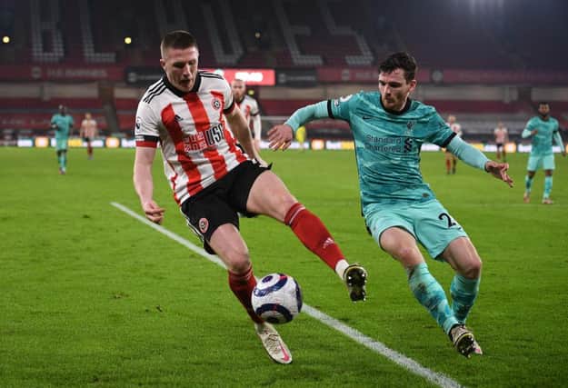 John Lundstram being closed down by Scotland captain Andy Robertson in a match between Sheffield United and Liverpool. Picture: Getty