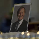Candles are lit next to a portrait of David Amess during a vigil for him at St Michaels Church, in Leigh-on-Sea, on Sunday