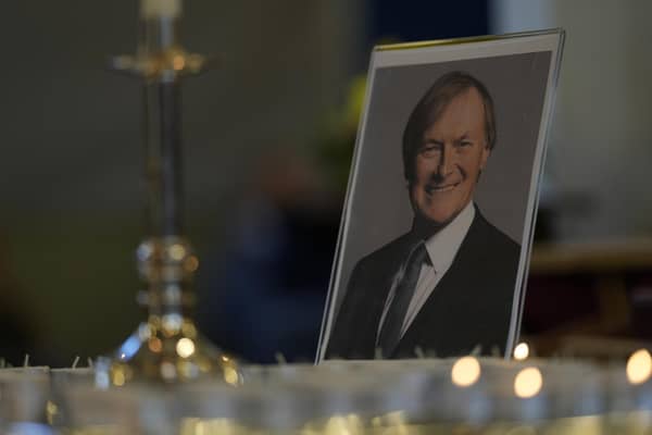 Candles are lit next to a portrait of David Amess during a vigil for him at St Michaels Church, in Leigh-on-Sea, on Sunday