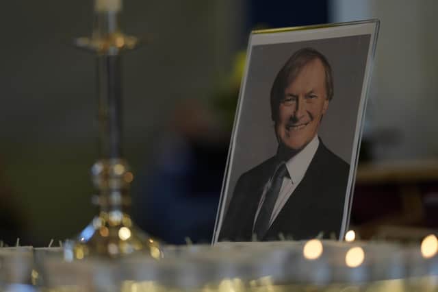 Candles are lit next to a portrait of David Amess during a vigil for him at St Michaels Church, in Leigh-on-Sea, on Sunday