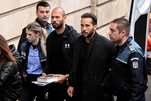 Former professional kickboxer and social media 'influencer' Andrew Tate (third from right) and his brother Tristan Tate (second from right) arrive at a courthouse in Bucharest on Tuesday (Picture: Daniel Mihailescu/AFP via Getty Images)