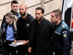 Former professional kickboxer and social media 'influencer' Andrew Tate (third from right) and his brother Tristan Tate (second from right) arrive at a courthouse in Bucharest on Tuesday (Picture: Daniel Mihailescu/AFP via Getty Images)