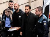 Former professional kickboxer and social media 'influencer' Andrew Tate (third from right) and his brother Tristan Tate (second from right) arrive at a courthouse in Bucharest on Tuesday (Picture: Daniel Mihailescu/AFP via Getty Images)