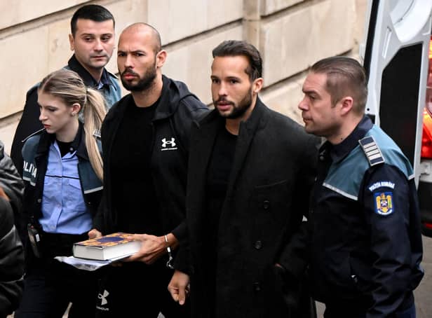 Former professional kickboxer and social media 'influencer' Andrew Tate (third from right) and his brother Tristan Tate (second from right) arrive at a courthouse in Bucharest on Tuesday (Picture: Daniel Mihailescu/AFP via Getty Images)
